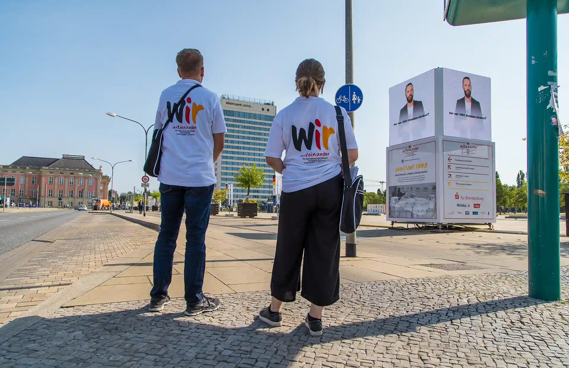 One picture shows two people or employees on the Day of German Unity.